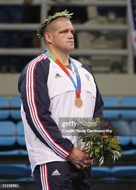 Rulon Gardner of the USA receives the bronze medal during ceremonies for the men's Greco-Roman wrestling 120 kg event on August 25, 2004 during the...