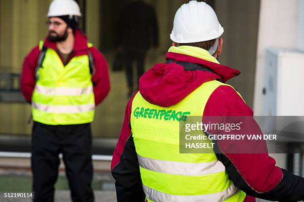 Greenpeace activists stands in front of Bollore's headquarters at La Defense business district, western Paris, on February 25, 2016. Greenpeace...
