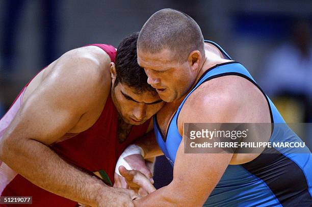 Sajad Barzi of Iran battles Rulon Gardner of the USA in the men's Greco-Roman 120 kg bronze medal match at the 2004 Olympic games, 25 August 2004 in...