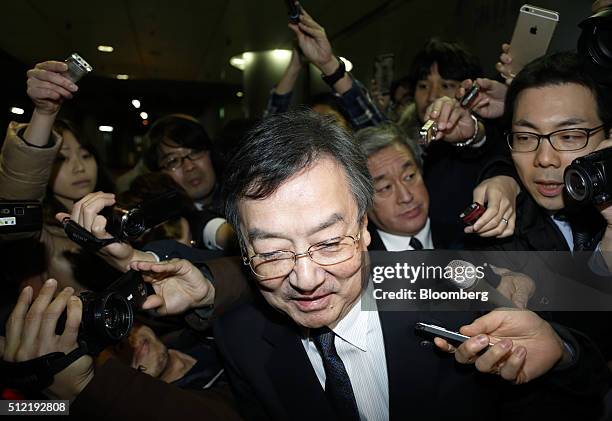 Kozo Takahashi, president of Sharp Corp., is surrounded by the media as he leaves the company's offices in Tokyo, Japan, on Thursday, Feb. 25, 2016....
