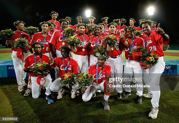 Gold medal winning team Cuba pose for a picture after receiving their medals during the medal ceremony for baseball on August 25, 2004 during the...