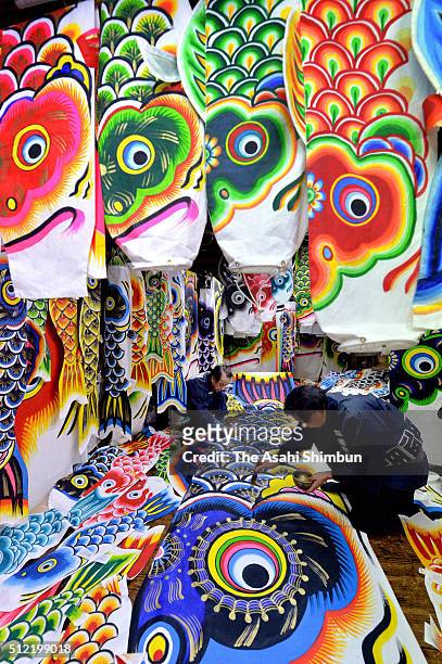 Workers paint a carp streamers at the Hashimoto Yakichi factory on February 24, 2016 in Kazo, Saitama, Japan. Japanese people pray for the health and...