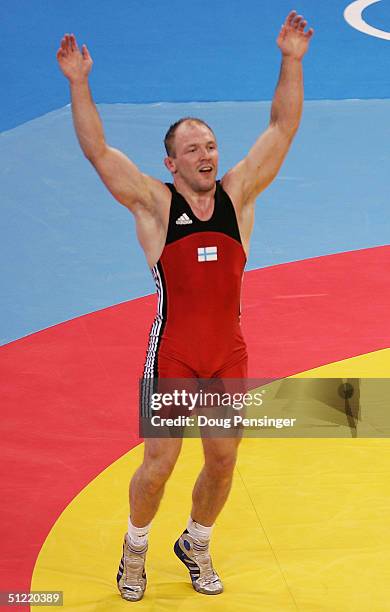 Marko Yli-Hannusela of Finland celebrates after defeating Reto Bucher of Switzerland during the men's Greco-Roman wrestling 74 kg semifinal round on...