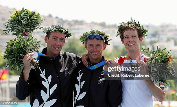 Bevan Docherty of New Zealand , Hamish Carter of New Zealand and Sven Riederer of Switzerland celebrate with their medals after winning the gold...