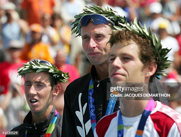 New Zealand's silver medallist Bevan Docherty, his compatriot gold medallist Hamish Carter and Switzerland's bronze medallist Sven Riederer stand on...