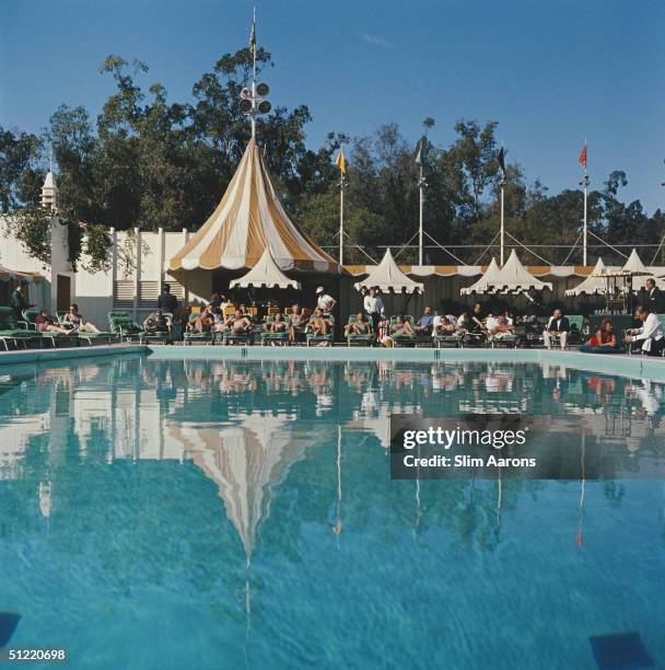 Holiday makers relaxing by the pool at the Beverly Hills Hotel on Sunset Boulevard in California, 1957.