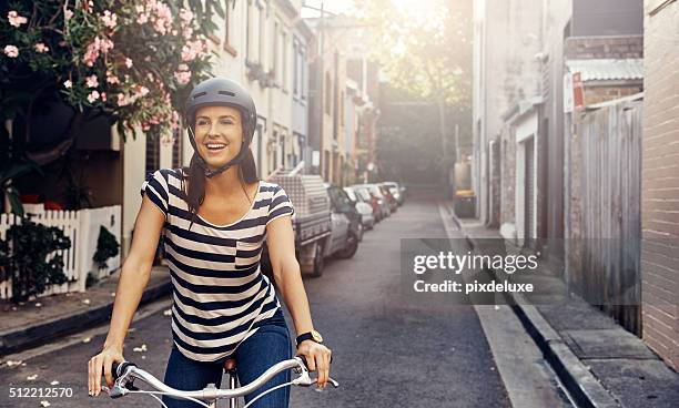 she loves cycling through the city - sports helmet stock pictures, royalty-free photos & images