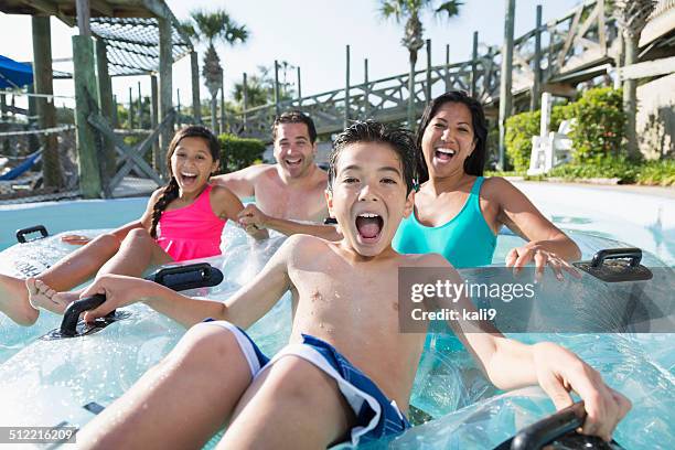family at water park - tween girl swimsuit stockfoto's en -beelden