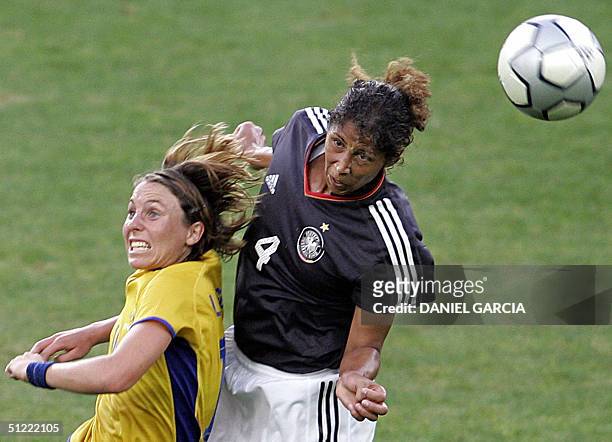 Swedish defender Sara Larsson and German defender Steffi Jones jump to intercept the ball during the bronze medal football match between Germany and...