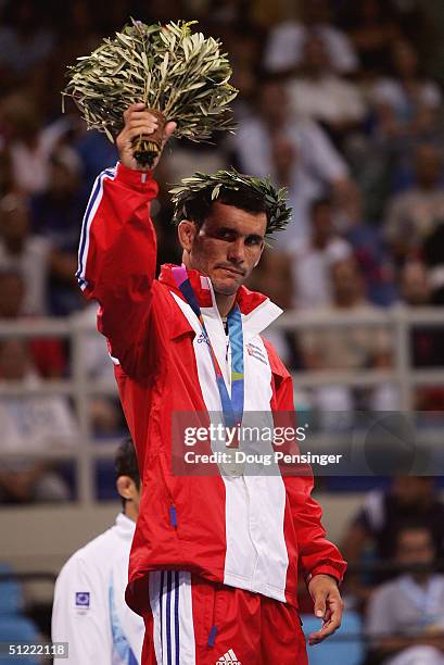 Silver medal winner Roberto Monzon of Cuba celebrates during the medal ceremony for the men's Greco-Roman wrestling 60 kg on August 26, 2004 during...