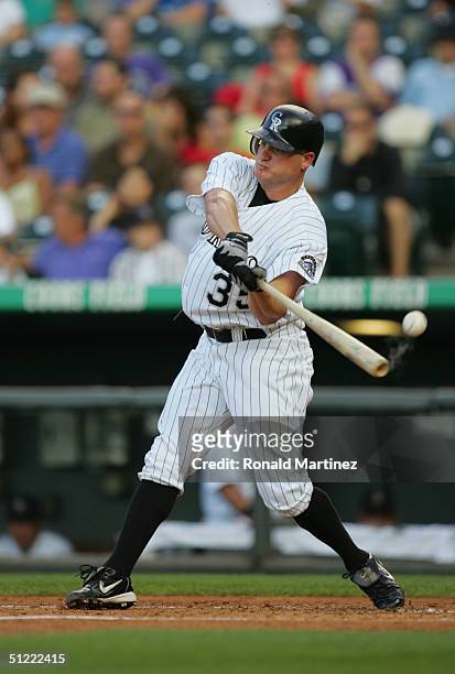 Jeromy Burnitz of the Colorado Rockies fouls off a pitch against the Cincinnati Reds on August 7, 2004 at Coors Field in Denver, Colorado. The...
