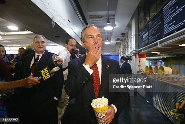 New York City Mayor Michael Bloomberg tests the popcorn in the cafe while on a tour of the Republican National Committee Media Center in James A....