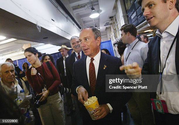 New York City Mayor Michael Bloomberg tests the popcorn in the cafe while on a tour of the Republican National Committee Media Center in James A....