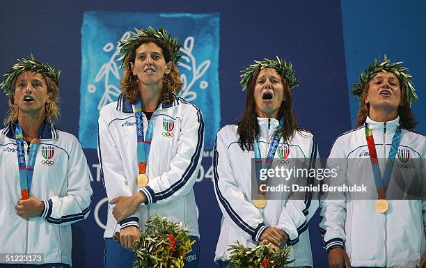 The Italian team sing their national anthem during the medal ceremony for women's Water Polo on August 26, 2004 during the Athens 2004 Summer Olympic...