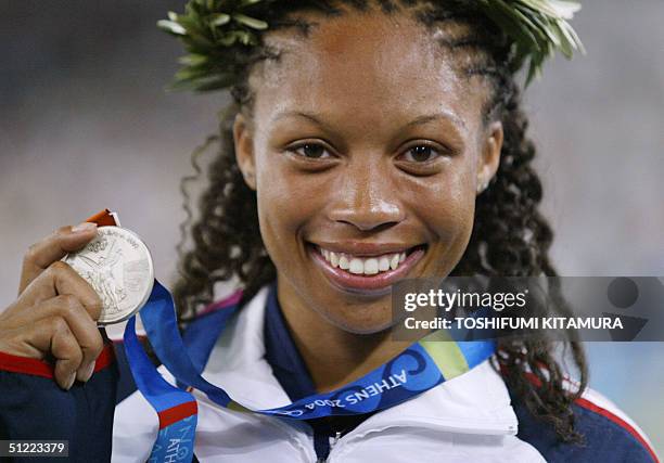 Silver medalist Allyson Felix of the USA celebrates on the podium of the women's 200m event at the Olympic Stadium 26 August 2004 during the Olympic...