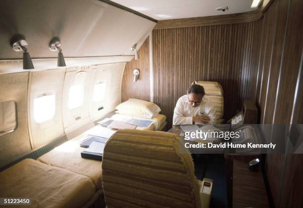 Secretary of State Henry Kissinger sits in the cabin of his aircraft on his last Mideast shuttle between Egypt and Israel during the Sinai II...