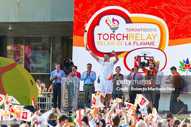 Toronto Raptor Greivis Vazquez carried the torch to the stage during the Panam or Pan American Games Torch Relay celebration at Nathan Phillips...