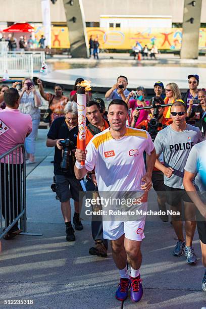 Toronto Raptor Greivis Vazquez carried the torch to the stage during the Panam or Pan American Games Torch Relay celebration at Nathan Phillips...
