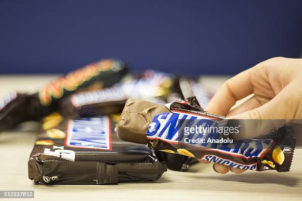 Woman shows a Snickers chocolate bar in her hand in Ankara, Turkey on February 25, 2016. American candy maker Mars announced Tuesday that it was...
