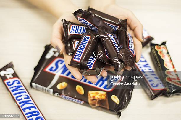 Woman shows Snickers chocolate bars in her hand in Ankara, Turkey on February 25, 2016. American candy maker Mars announced Tuesday that it was...