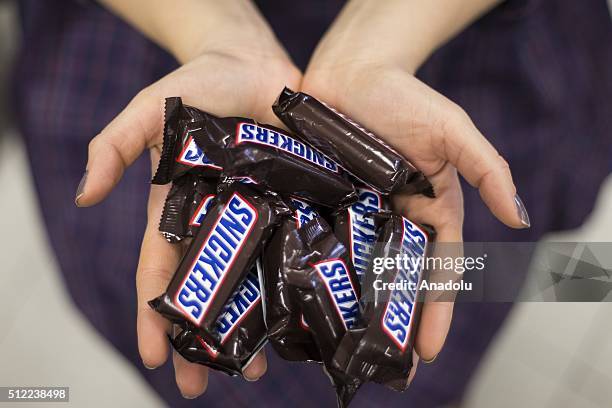 Woman shows Snickers chocolate bars in her hand in Ankara, Turkey on February 25, 2016. American candy maker Mars announced Tuesday that it was...