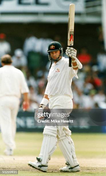 Mark Waugh of Australia celebrates after reaching a half century during the 2nd Test Match between South Africa and Australia March 14, 1997 in Port...