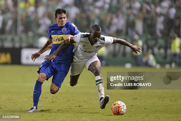 Colombian Deportivo Cali defender Helibelton Palacios vies for the ball with Argentine Boca Juniors defender Jonathan Silva during their Copa...
