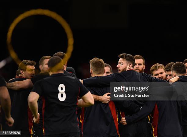 Wales winger Alex Cuthbert looks on in a team huddle during the Wales captain's run ahead of their RBS Six Nations match against France at...