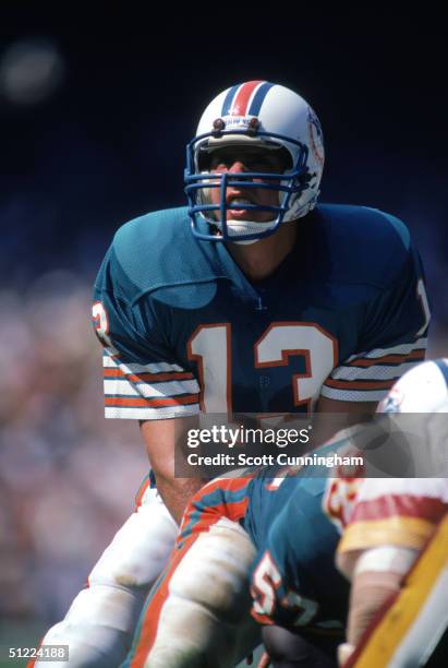 Quarterback Dan Marino of the Miami Dolphins prepares to snap the ball at the line of scrimmage during a game against the Washington Redskins at RFK...