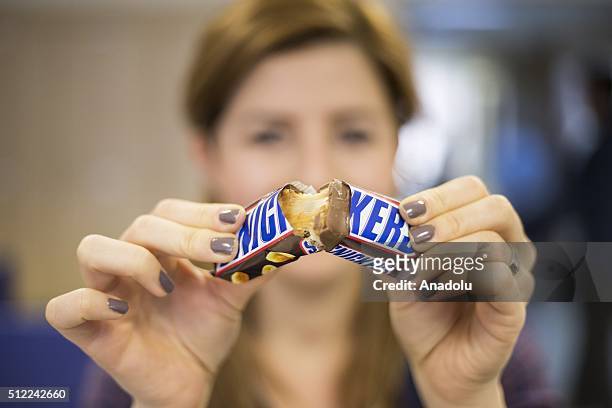 Woman shows a Snickers chocolate bar in her hand in Ankara, Turkey on February 25, 2016. American candy maker Mars announced Tuesday that it was...