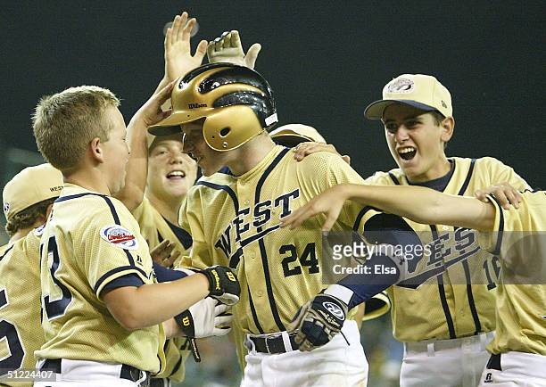 Josh Lister of California is congratulated by teammates after he hit a home run against Maryland during the U.S. Semi-final of the Little League...