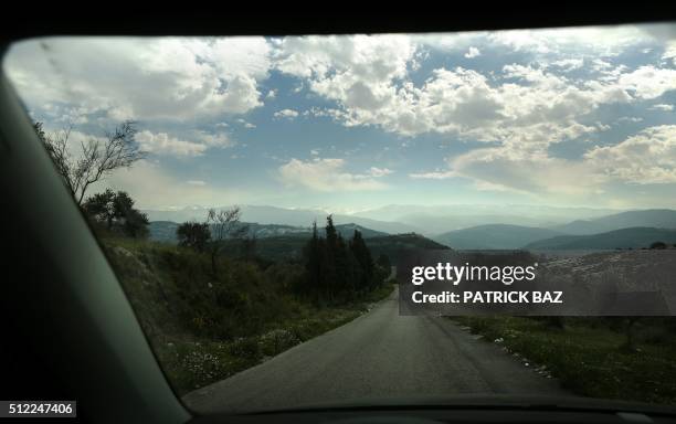 The Mount Lebanon mountain chain is seen through windshield of a car from the Koura district north of the capital Beirut, on February 25, 2016.