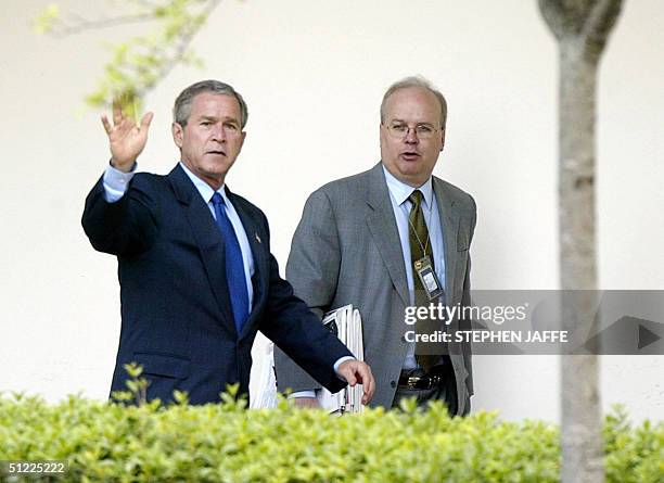 This picture taken on 07 May 2004 shows US President George W. Bush walking with his senior advisor Karl Rove along the colonnade from the Oval...