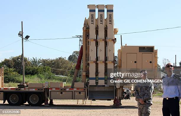 An Israeli air force soldier and an American air force soldier stand near the Israeli Defense Forces military system David's Sling after viewing...