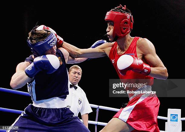 Song Guk Kim of the People's Republic of Korea and Vitali Tajbert of Germany compete during the men's boxing 57 kg semifinal bout on August 27, 2004...