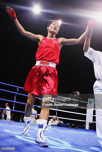 Song Guk Kim of the People's Republic of Korea celebrates after defeating Vitali Tajbert of Germany in the men's boxing 57 kg semifinal bout on...