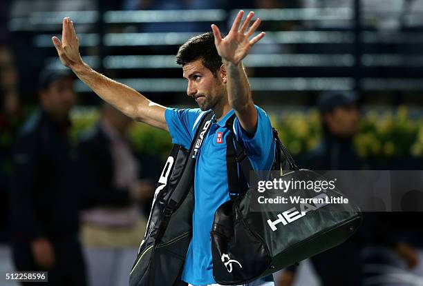 Novak Djokovic of Serbia leaves the court as he withdraws from his quarter final match against Feliciano Lopez of Spain on day six of the ATP Dubai...