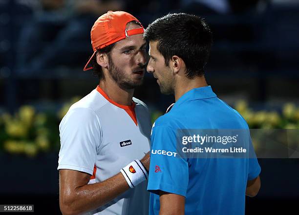 Novak Djokovic of Serbia shakes hands with Feliciano Lopez of Spain as he withdraws from his quarter final match on day six of the ATP Dubai Duty...