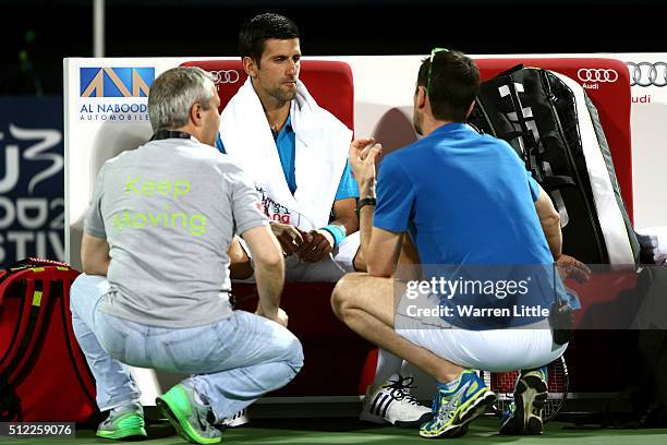 Novak Djokovic of Serbia receives medical attention on court during his quarter final match against Feliciano Lopez of Spain on day six of the ATP...