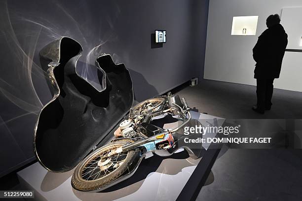 Man looks at the sculpture "Etui pour mobylette" by Wim Delvoye during the exibition "Carambolage" on February 25, 2016 at the Grand Palais in Paris....