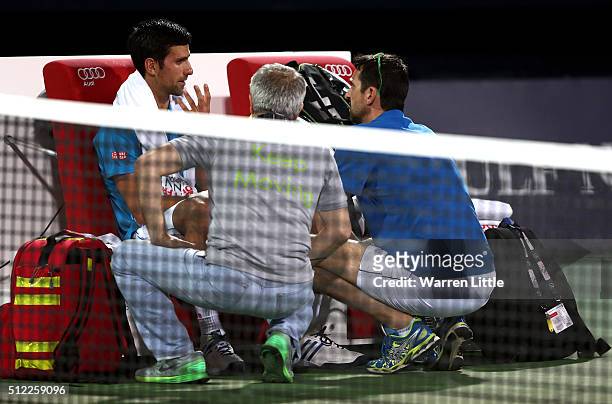 Novak Djokovic of Serbia receives medical attention on court during his quarter final match against Feliciano Lopez of Spain on day six of the ATP...