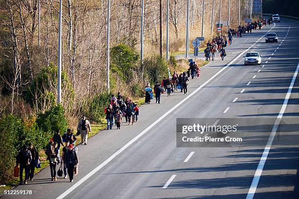 Refugees from Syria walk along the highway towards the border with Macedonia where refugees and migrants remain stuck on February 25, 2016 in...