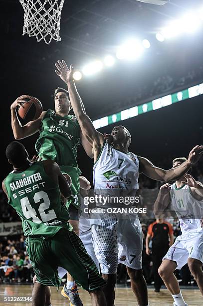 Unicaja Malaga's center Richard Hendrix vies for the ball with Darussafaka Dogus Istanbul's forward Milko Bjelica and center Marcus Slaughter during...