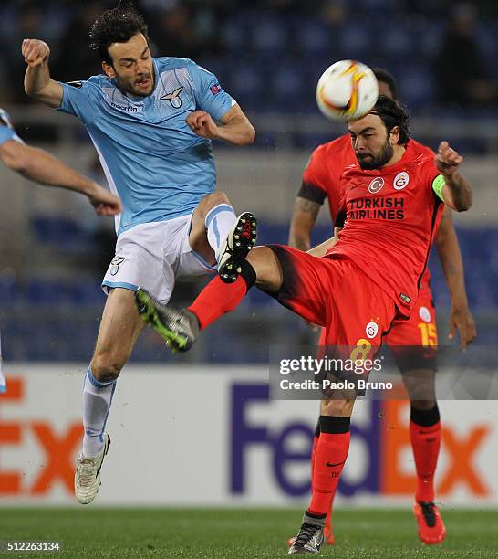 Inan Selcuk of Galatasaray competes for the ball with Marco Parolo of SS Lazio during the UEFA Europa League Round of 32 second leg match between...