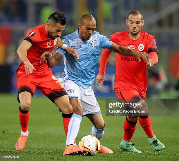 Yasin Oztekin with Wesley Snijder of Galatasaray competes for the ball with Abdoulay Konko of SS Lazio during the UEFA Europa League Round of 32...