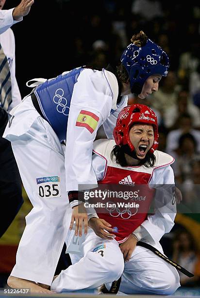 Nootcharin Sukkhongdumnoen of Thailnad reacts after getting a knee in the groin from Soni Reyes of Spain in the women's under 57 kg Taekwondo...