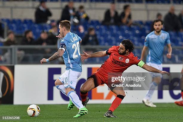 Luacas Biglia of SS Lazio and Galatasaray's Selcuk Inan vie for the ball during the UEFA Europa League, Round of 32 second leg match between SK...