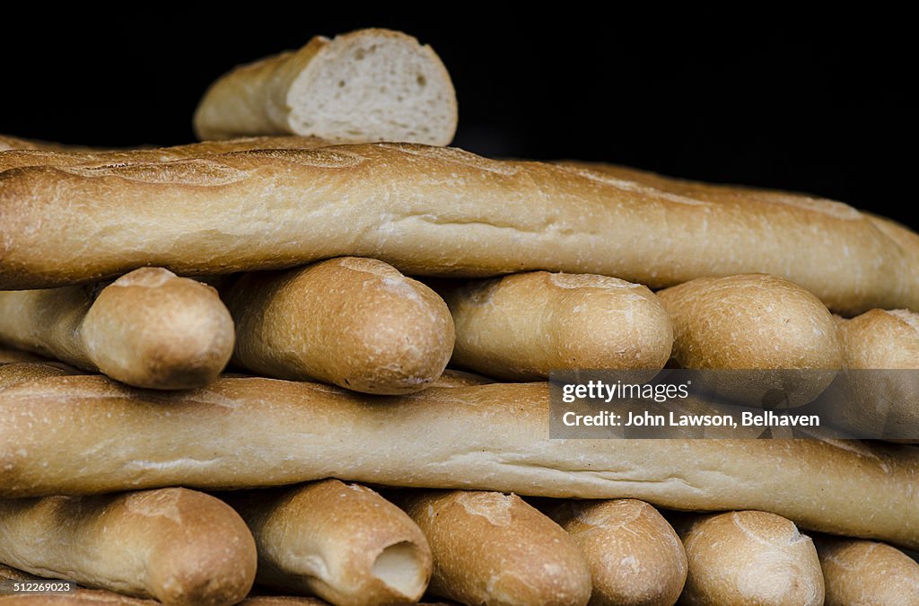 A stack of French bread baguettes