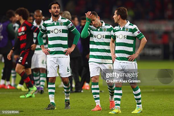 Alberto Aquilani, Jefferson and Joao Pereira of Sporting react after the UEFA Europa League round of 32 second leg match between Bayer Leverkusen and...