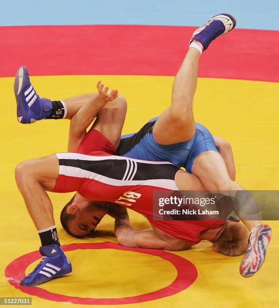 Cael Sanderson of the United States and Siarhei Borchanka of Belarus compete during the men's Freestyle wrestling 84 kg elimination round on August...